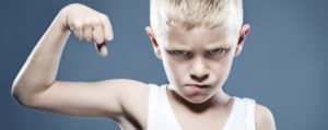 Young child showing his muscles