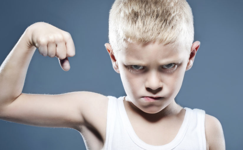 Young child showing his muscles